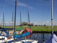 Small yacht harbour in typical open wide countryside of Dutch province Friesland  Small yacht harbour in typical open wide countryside of Dutch province Friesland : countryside, open wide, room, flat, agriculture, agricultural, farmland, green, blue sky, white clouds, clouds, meadow, pasture, rural, rural landscape, landscape, non-urban landscape, outside, nature, natural, outdoor, outdoors, no people, nobody, summer, summertime, day, daytime, Oudega, Aldegea, sudwest-fryslan, friesland, fryslan, netherlands, holland, dutch, europe, european, ditch, water, horizon, non-urban scene, yacht, harbour, harbor