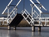 NL, Zuid-Holland, Molenlanden, Kinderdijk 6, Saxifraga-Roel Meijer  Opened wooden draw bridge, Unesco World Heritage Site Kinderdijk, South Holland, Netherlands : icy, winter, wintertime, blue sky, reed, reflection, reflected, unesco world heritage site, Kinderdijk, South Holland, Holland, Netherlands, wooden, bridge, draw bridge, open, travel destinations. canal, ice
